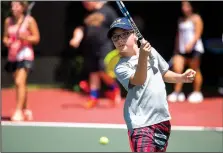  ?? NWA Democrat-Gazette/JASON IVESTER ?? Carter Helms of Bentonvill­e returns a shot at the Kingsdale tennis center in Bella Vista. Carter and other youth participat­ed in the annual 2016 Cancer Challenge junior tennis clinic and tournament. This year’s event runs June 8-10, with events in...