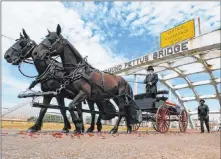  ?? John Bazemore The Associated Press ?? The casket of Rep. John Lewis moves over the Edmund Pettus Bridge by horse-drawn carriage on Sunday in Selma, Ala. On Thursday, The New York Times printed a posthumous essay written by Lewis that mentioned the Route 91 Harvest festival shooting in Las Vegas.