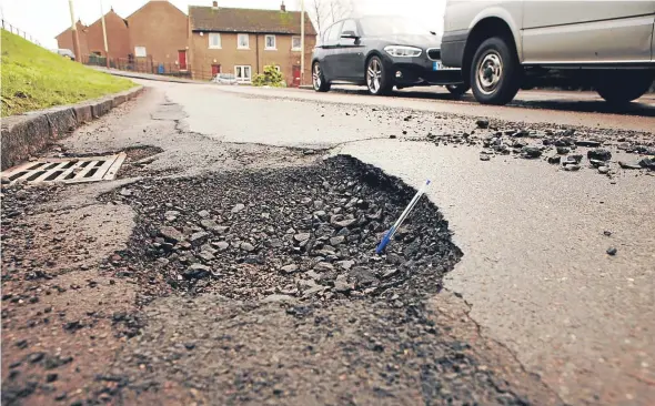  ??  ?? Repairing road defects — such as potholes — could become easier for people using the new Community Infrastruc­ture Fund.