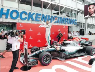  ?? JENS MEYER/THE ASSOCIATED PRESS ?? Lewis Hamilton of Britain celebrates in victory lane after winning the German Grand Prix Sunday in Hockenheim, Germany.
