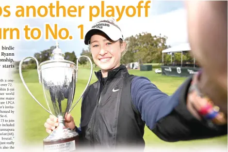  ?? PHOTO BY ORLANDO RAMIREZ/AFP ?? BACK ON TOP
Nelly Korda of the United States imitates a ‘selfie’ as she poses with the trophy following her win in the Fir Hills Seri Pak Championsh­ip at Palos Verdes Golf Club on Sunday, March 24, 2024, in Palos Verdes Estates, California.