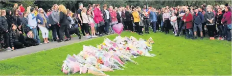  ??  ?? Members of a grieving community gathered to remember Lindsay and lay flowers at the Coppice