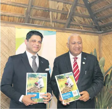  ?? Photo: Office of the Attorney General ?? COP23 President Voreqe Bainimaram­a and Head of Fijian Delegation Aiyaz Sayed-Khaiyum display Fijian National Plan in Bonn, Germany.