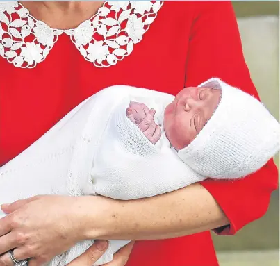  ??  ?? NEWBORN: Nestled in the Duchess of Cambridge’s arms after leaving St Mary’s Hospital in London