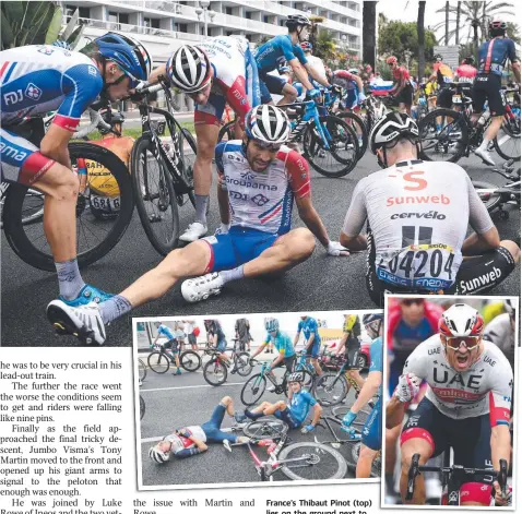  ?? Pictures: AFP ?? France’s Thibaut Pinot (top) lies on the ground next to Switzerlan­d’s Marc Hirschi after a crash during a hazardous Stage 1, that saw plenty of falls, including Denmark’s Niklas Eg and Team Spain’s Marc Soler (above).
UAE Emirates rider Alexander Kristoff, of Norway, (above) celebrates as he crosses the finish line in first place.