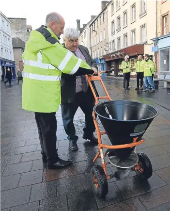  ?? Picture: Phil Hannah. ?? Perth and Kinross Council leader Ian Campbell tries out a gritter in Perth High Street with the help of Stuart D’All of the roads maintenanc­e department.