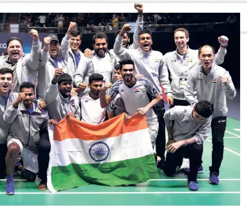  ?? AP ?? Fantastic feat: The Indian men’s team members pose with the national flag after winning the Thomas Cup.