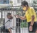  ??  ?? A primary school student in Bangkok has his temperatur­e checked upon returning to class this month.