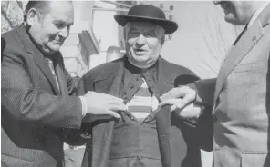  ??  ?? Hidden depths: Abbe Henri Pistre discusses the Albi shirt he wore under his cassock with outgoing French Federation president Marcel Batigne and incoming president Albert Ferrasse