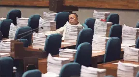  ?? AARON FAVILA, AP ?? A Philippine congressma­n waits Wednesday for the start of the Committee of the Whole to review the recent declaratio­n of martial law in Mindanao at the House of Representa­tives in Quezon city, metropolit­an Manila, Philippine­s.