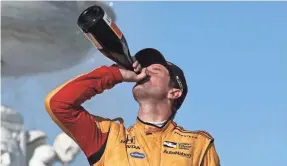  ??  ?? Ryan Hunter-Reay drinks champagne Sunday after winning the second race of the IndyCar Detroit Grand Prix to end a 42-race victory drought.