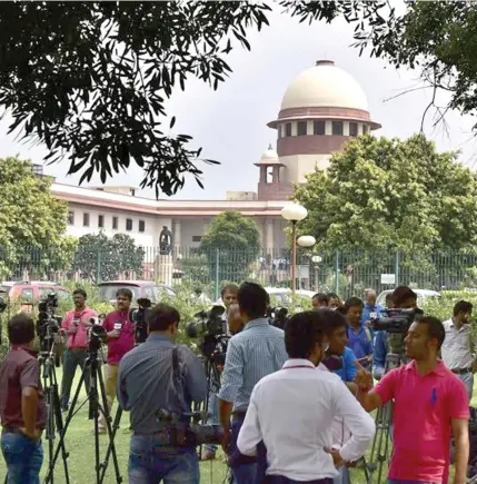  ??  ?? Journalist­s stand outside the Supreme Court in New Delhi.