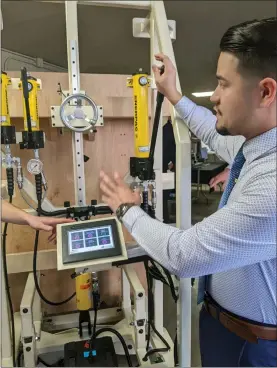  ?? JENNIE BLEVINS — ENTERPRISE-RECORD ?? Chico State engineerin­g senior Nicholas Westerband demonstrat­es his team’s project, a 2 MJ Blast Door Extractor with embedded monitoring Friday at the Chico State College of Engineerin­g, Computer Science and Constructi­on Management Senior Design Expo in Chico.