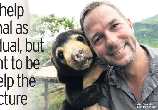  ??  ?? Giles Clark with Mary the Sun Bear