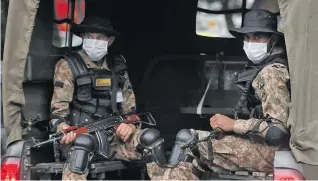  ??  ?? Pakistan Army personnel wearing facemasks patrol in vehicles on a street in Islamabad on June 12, 2020.