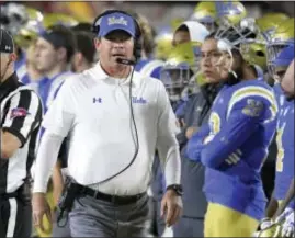  ?? MARK J. TERRILL — THE ASSOCIATED PRESS ?? UCLA head coach Jim Mora walks the sideline Saturday against Southern California in Los Angeles. Mora was fired after No. 12 Southern Cal beat crosstown rival UCLA, 28-23.
