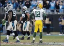  ?? BOB LEVERONE — THE ASSOCIATED PRESS ?? Green Bay‘s Aaron Rodgers (12) watches as Carolina players walk off the field after a Packers fumble late during the second half in Charlotte, N.C., Sunday.