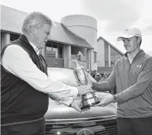  ?? Stuart Franklin / Getty Images ?? Jordan Spieth, winner of the 146th Open Championsh­ip, returned the Claret Jug to R&amp;A chief executive Martin Slumbers, left, on Monday, a symbol of his last PGA Tour win.