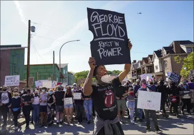  ?? STEVE MELLON — THE ASSOCIATED PRESS ?? Dínico Perry-Ellis leads a chant June 1on Station Street in Pittsburgh, protesting the death of George Floyd, who died after being restrained by Minneapoli­s police officers May 25.