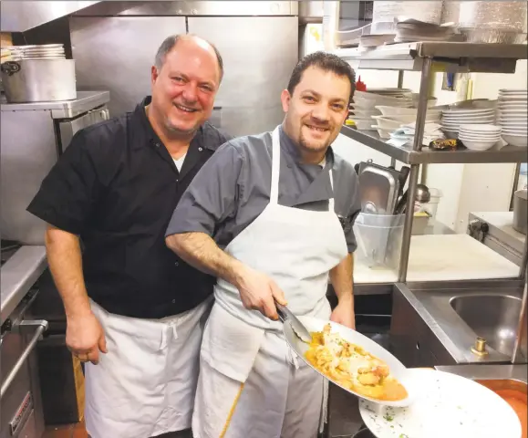  ?? Stephen Fries / For Hearst Connecticu­t Media ?? Owner Vincenzo LoMonaco, with Chef Atlante Esposito plating the Gamberoni Monachina, at his Branford restaurant.