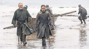  ?? HBO ?? Davos ( Liam Cunningham) and Jon ( Kit Harington) arrive at Dragonston­e after a seemingly uneventful trip on Thrones.
