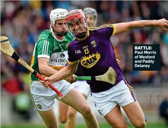  ??  ?? BATTLE: Paul Morris of Wexford and Paddy Delaney