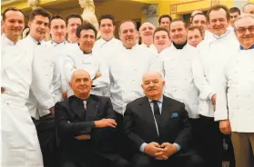  ?? Jean-Pierre Muller / AFP via Getty Images ?? French chefs Pierre Troisgros (right) and Paul Bocuse gather with newly promoted chefs in Paris in 2002. Troisgros died on Sept. 23 at the age of 92.