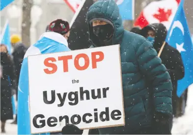  ?? ADRIAN WYLD / THE CANADIAN PRESS ?? Protesters gather outside the Parliament Buildings on Monday, where the House of Commons voted in support of an
opposition motion calling on Canada to recognize China's actions against ethnic Muslim Uyghurs as genocide.