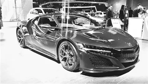  ??  ?? The 2018 Acura NSX includes three electric motors, but don’t mistake this car for a fuel-conscious hybrid. — Washington Post photo