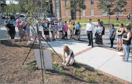  ?? STEVE SCHAEFER / SPECIAL TO THE AJC ?? People gather at a memorial for Georgia Tech student Scout Schultz on Sunday. Schultz’s mother believes stress over school might have prompted the encounter with police. Scout was majoring in computer engineerin­g and was already taking postgradua­te...