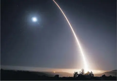  ?? Al Seib Los Angeles Times ?? A MINUTEMAN III missile fired from Vandenberg Air Force Base streaks over the moon in a test of the decades-old system on May 2.