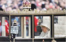  ?? Frank Augstein / Associated Press ?? Britain’s Queen Elizabeth II rides in a carriage to attend the annual Trooping the Color ceremony in her honor in London.