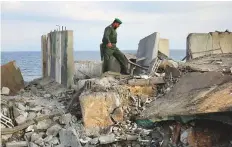  ?? AFP ?? A Palestinia­n security force member walks on debris after an Israeli regime air strike around Rafah city yesterday.