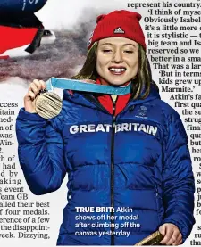  ??  ?? TRUE BRIT: Atkin shows off her medal after climbing off the canvas yesterday