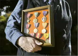  ?? (NWA Democrat-Gazette/Charlie Kaijo) ?? Albert Eugene “Gene” King has a box full of medals from his service in three wars — World War II, Korea and Vietnam. The 93-year-old veteran, who lives in Fayettevil­le, says he didn’t do anything special, just served his country.