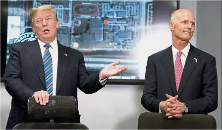  ??  ?? Making a point: Trump accompanie­d by Florida Gov Rick Scott (right) speaking to reporters after their meeting with law enforcemen­t officers at Broward County Sheriff’s Office in Pompano Beach, Florida. — AP