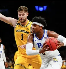  ?? Frank Franklin II/Associated Press ?? Pitt’s Blake Hinson tries to drive past Michigan’s Hunter Dickinsoni­n the second half Wednesday in New York.