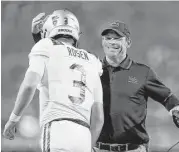  ?? Christian Petersen / Getty Images ?? UCLA coach Jim Mora has a big smile for Josh Rosen after the freshman quarterbac­k scored on an 8-yard run in the third quarter of the Bruins’ victory.