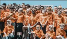  ?? CONTRIBUTE­D ?? Former Wayne High School and Ohio State football standout Braxton Miller with children from his CHARG1NG Camp.
