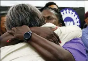  ?? THE ASSOCIATED PRESS ?? United Auto Workers members, some Nissan employees and supporters console one another as they express their disappoint­ment at losing their bid to form a union at the Nissan vehicle assembly plant in Canton, Miss. on Friday