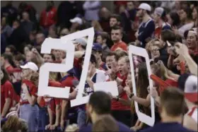  ?? YOUNG KWAK — THE ASSOCIATED PRESS ?? Fans in the Gonzaga student section hold signs that state “27-0”, the team’s record after the anticipate­d win against San Francisco during the second half of an NCAA college basketball game in Spokane, Wash., on Feb. 16.