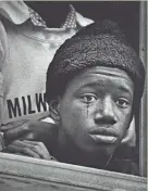  ?? ERWIN GEBHARD/MILWAUKEE JOURNAL ?? A young man joins mourners at St. Boniface Church on April 8, 1968. For more photos, see jsonline.com/ green sheet.