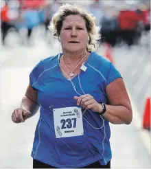  ?? CLIFFORD SKARSTEDT/EXAMINER ?? Runner Jeannette Larsen competes in the 10 K race in the third annual Merrett Home Hardware Canadian Mental Health Associatio­n, Haliburton, Kawartha, Pine Ridge (CMHA HKPR) Run for Mental Health on Saturday on Charlotte St.