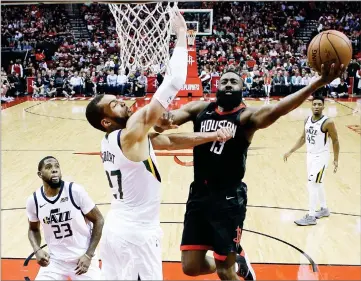  ?? AP PHOTO BY ERIC CHRISTIAN SMITH ?? Houston Rockets guard James Harden, right, drives to the basket as Utah Jazz center Rudy Gobert, left, defends during the second half in Game 5 of an NBA basketball second-round playoff series, Tuesday, May 8, in Houston.