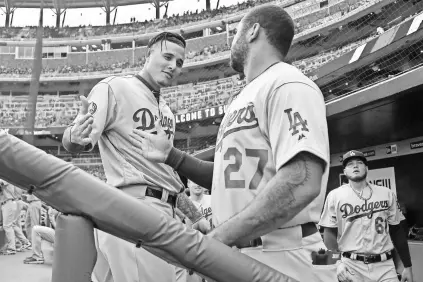  ?? BRETT DAVIS/USA TODAY SPORTS ?? Since joining the Dodgers on July 20, third baseman Manny Machado, talking with right fielder Matt Kemp (27), had hit .302 entering the week.