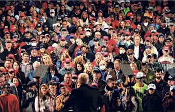  ?? Andrew Caballero-reynolds / Getty Images ?? Supporters listen as President Donald Trump speaks at a rally to support Republican Senate candidates in Valdosta, Ga., on Dec. 5. Trump’s rally planned on the eve of the Senate runoffs is raising concerns among Georgia residents because of the coronaviru­s.