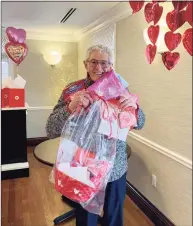  ?? Photo courtesy of Parsonage Cottage ?? Parsonage Cottage resident Les Russo shows the gifts he received on Valentine’s Day from the community. He and all the Parsonage Cottage residents, as well as the staff, received gift baskets and cards — from community donations.