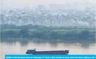  ??  ?? HANOI: In this file photo taken on September 27, 2019, a thick blanket of smog covers the Hanoi skyline as the sun sets. — AFP