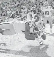  ?? Albert Cesare / Montgomery Advertiser ?? Wide receiver Stephen Sullivan scores the first touchdown for LSU on a 1-yard run in the second quarter as the Tigers began their comeback.