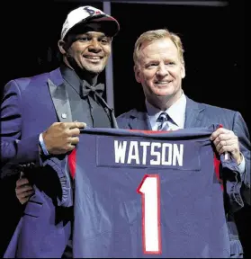  ?? ELSA / GETTY IMAGES ?? Gainesvill­e’s Deshaun Watson stands with NFL commission­er Roger Goodell after going 12th overall in the draft to the Houston Texans.